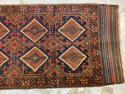 Lot 1062 - Eastern runner with geometric decoration on red and blue ground, 249cm x 78cm