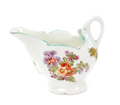Lot 191 - A Lowestoft 'Dolphin Ewer' cream boat, painted in 'Tulip Painter' style, circa 1780