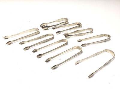 Lot 326 - Nine pairs of Georgian and Victorian silver sugar tongs, most with bright cut engraved decoration, various dates and makers, (9)