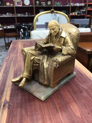 Lot 192 - Art Nouveau style gilt metal figural bookend in the form of a seated gentleman, signed J Ruhl