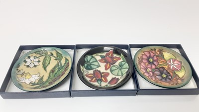 Lot 1106 - Set of eleven Moorcroft pin dishes, various patterns, all boxed