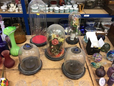 Lot 15 - Three antique glass domes (two with artificial flowers) together with two glass-domed lanterns with blue glass shell-form tops (5)