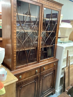 Lot 906 - Georgian style mahogany two height bookcase with adjustable shelves above enclosed by two astragal glazed doors, two drawers and two doors below, 115cm wide, 40cm deep, 206cm high