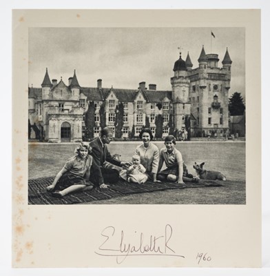 Lot 73 - H.M.Queen Elizabeth II, signed 1960 Christmas card with twin gilt ciphers to cover, charming photograph of the Royal couple with their children and corgis seated on a rug in the garden of Balmoral,...