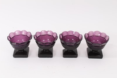 Lot 271 - A set of four 19th century amethyst tinted glass salts