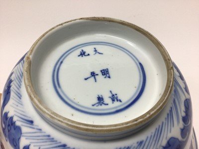 Lot 129 - Fine Chinese blue and white bowl, Kangxi period, of round form with straight foot and flared rim, decorated with dragons chasing flaming pearls, amongst stylised clouds and waves, prunus flowers on...