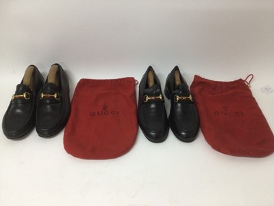 Lot 2174 - Gucci Mens Shoes. Two pairs of black Horse Bit Loafers. Size 42 and 43. Both with shoes trees and soft red Gucci bags. Pre-worn but good condition.