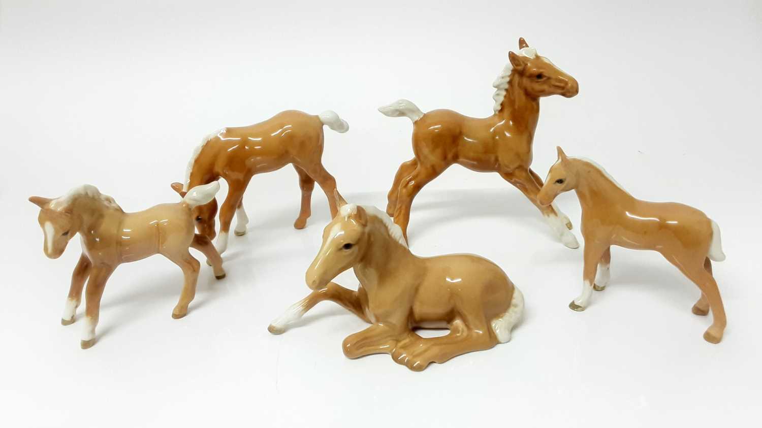 Lot 78 - Five Beswick Palamino Foals including Foal (lying) model no. 915, designed by Arthur Gredington, 8.3cm high