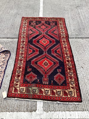 Lot 1126 - Eastern rug with geometric decoration on red and blue ground