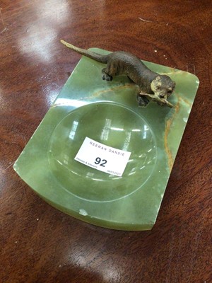 Lot 92 - Onyx dish surmounted by a cold painted otter holding a fish