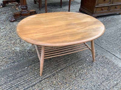 Lot 1109 - Ercol oval coffee table with magazine rack undertier