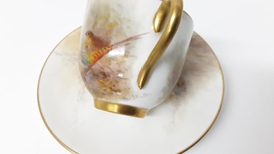 Lot 1247 - Royal Worcester cabinet cup and saucer, hand decorated with a Pheasant, signed Jas Stinton