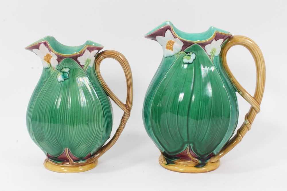 Lot 46 - Two Victorian Minton majolica jugs, moulded with large leaves and flowers, model numbers 1228, 20cm and 22.5cm high
