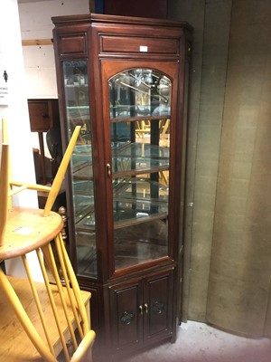 Lot 1057 - Chinese hardwood two height corner cabinet with glazed top above panelled doors