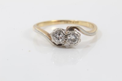 Lot 221 - 18ct gold diamond two stone cross over ring in platinum illusion setting