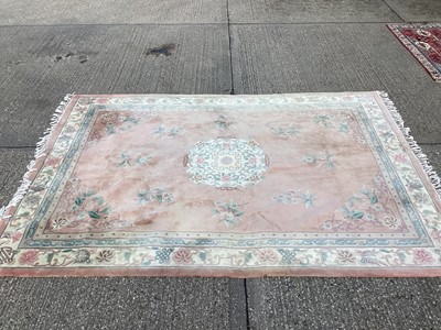 Lot 1124 - Large Chinese wash rug with floral decoration on pink, green and cream ground, 370cm x 268