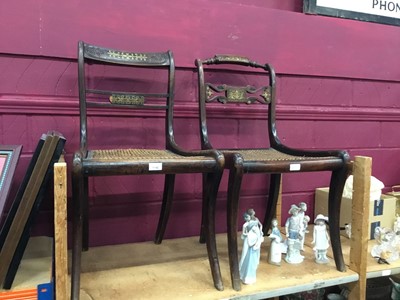 Lot 1140 - Two Regency brass inlaid dining chairs on sabre legs