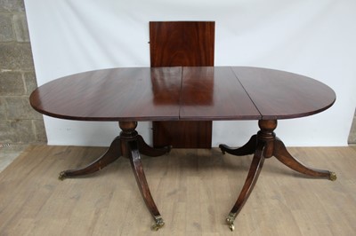 Lot 1159 - Regency style mahogany twin pillar dining table