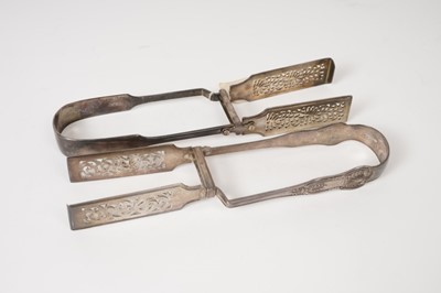 Lot 381 - Two pairs Victorian silver asparagus servers