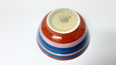Lot 1352 - Two Clarice Cliff for Liberty's 'Bizarre' bowls with polychrome painted horizontal stripes, signed 'Liberty's' and printed Bizarre mark. 19cm and 21cm diameter (2)