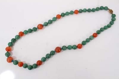 Lot 84 - Chinese green jade/hard stone and carnelian polished bead necklace with silver gilt clasp, 70cm long