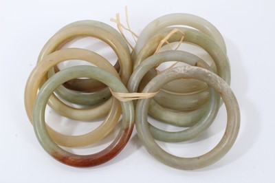 Lot 86 - Ten green jade/hard stone polished bangles