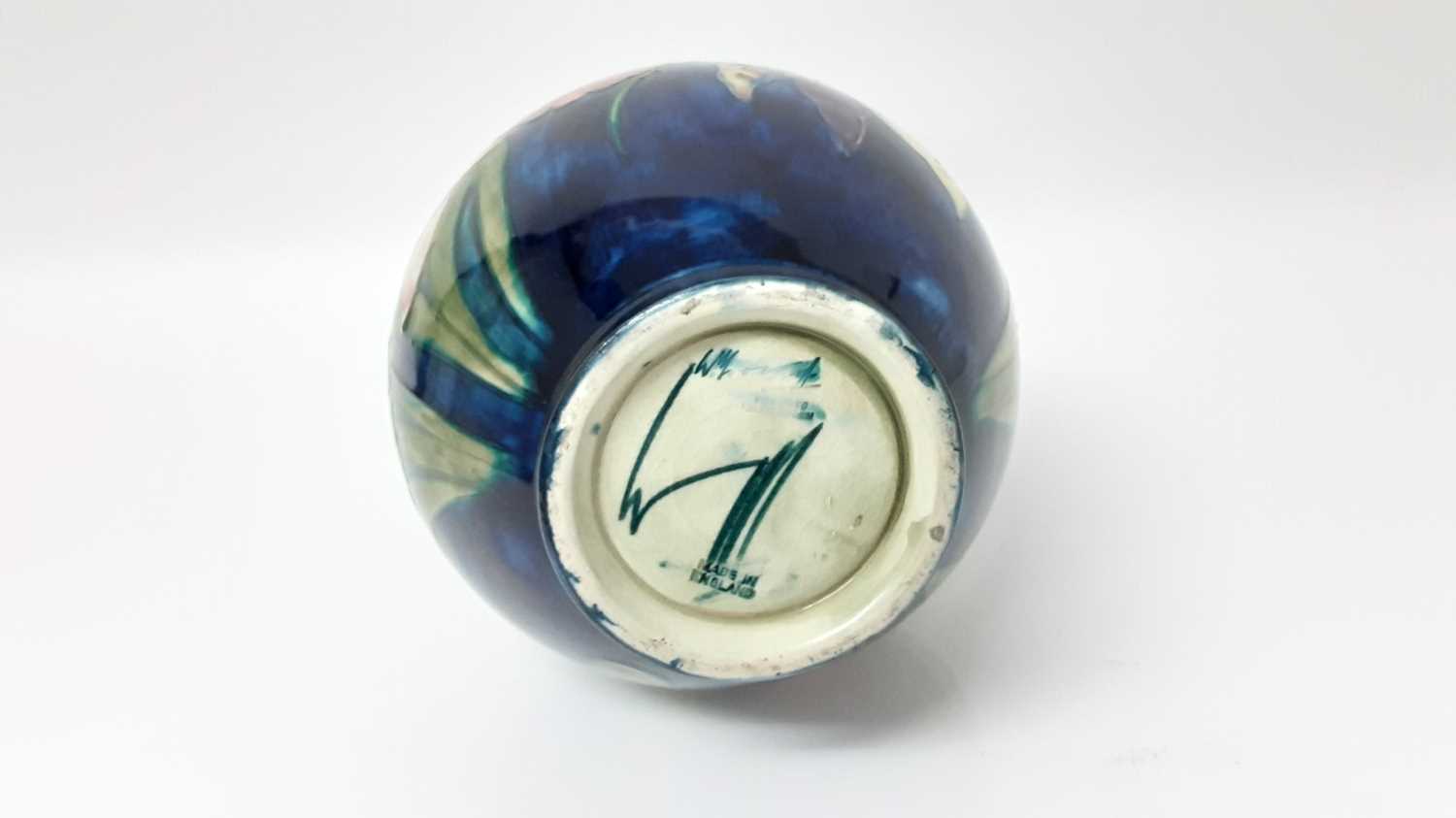 Lot 1205 - Moorcroft vase with floral decoration on blue ground, impressed marks and blue painted signature to base, 22cm high