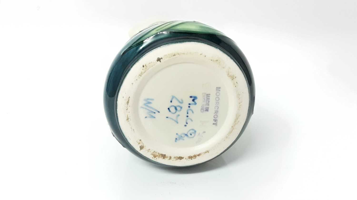 Lot 1210 - Moorcroft pottery jug with floral decoration on cream and blue ground, 24cm high