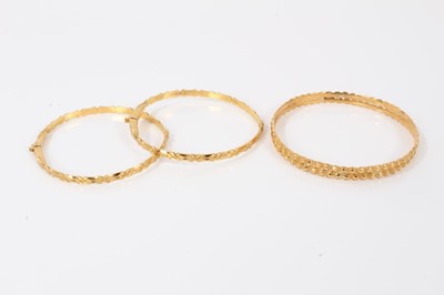 Lot 139 - Three Indian yellow metal bangles
