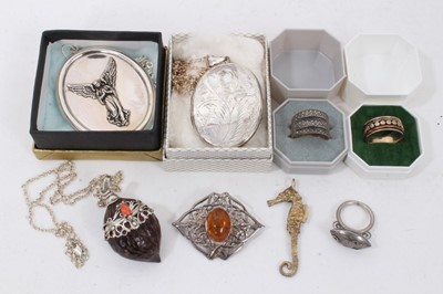 Lot 231 - Large oval silver locket on chain, large oval silver angel pendant on chain, silver gilt seahorse pendant, silver mounted nut pendant on chain, silver amber brooch and three rings