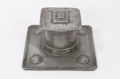 Lot 2676 - A Liberty Tudric Pewter inkwell designed by Archibald Knox, model no.0141, square section tray with tapering drum well and hinged square section cover, cast in low relief with foliate panels, with...