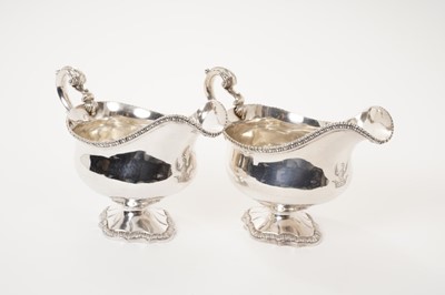 Lot 209 - Pair of George III silver sauce boats with gadrooned edging and scroll handles on pedestal  bases