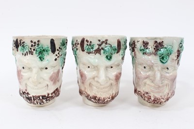 Lot 12 - Group of nine 18th and early 19th century Staffordshire Satyr-mask jugs, including Whieldon and Pratt type examples, 9cm to 12.5cm high