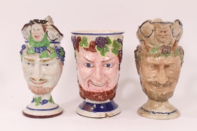 Lot 14 - Three large early 19th century Staffordshire pottery Satyr-mask jugs, 18.5cm to 22cm high
