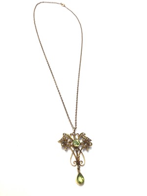 Lot 43 - Edwardian 15ct gold peridot and seed pearl open work pendant on chain