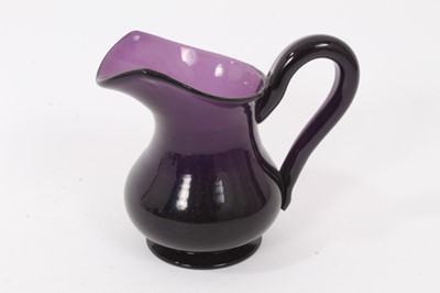 Lot 107 - A 19th century amethyst tinted glass helmet shaped cream jug