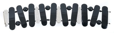 Lot 459 - Contemporary diamond and black onyx bracelet with pavé set diamond panels interspaced by black onyx panels, in 18ct white gold setting.