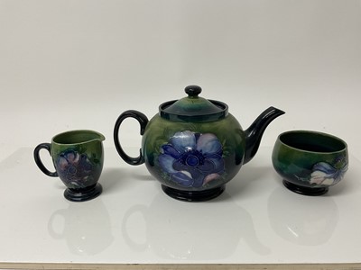 Lot 1098 - Moorcroft pottery poppy pattern teapot with sugar bowl and milk jug