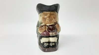 Lot 1142 - Doulton Lambeth stoneware Toby jug, shown holding a jug and mug of frothing beer