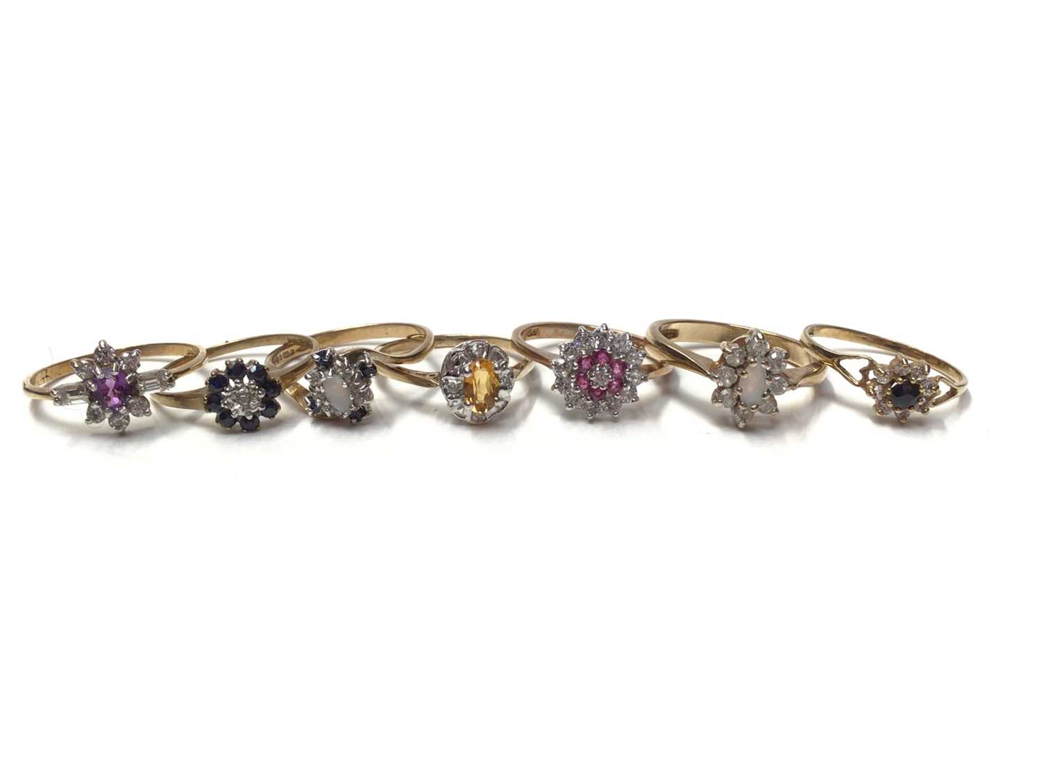 Lot 23 - Seven 9ct gold gem set cluster rings
