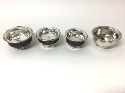 Lot 215 - Three Tibetan silver mounted wooden bowls together a Tibetan silver plated bowl