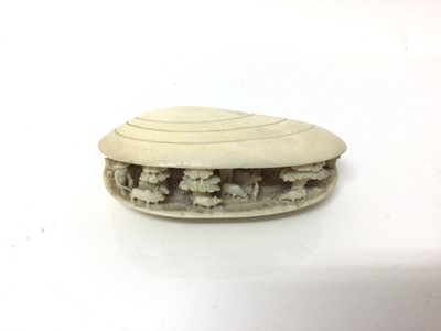 Lot 11 - 19th century Japanese ivory clam shell diorama, the inside with figures, livestock, trees and buildings, 10cm across