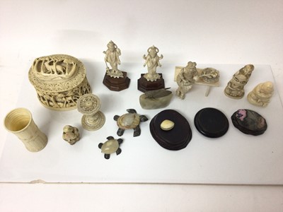 Lot 15 - Group of antique ivory, including a pair of Indian figures of gods, a dice shaker, a relief carved box, an okimono, a Canton puzzle ball stand, a clam netsuke, and two other figures, along with sto...