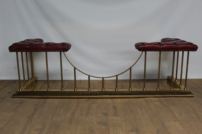 Lot 1337 - Good antique style brass club fender with maroon leather buttoned seats, on reeded supports
