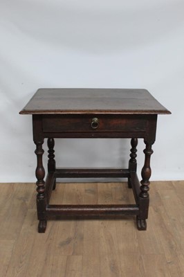 Lot 1343 - Early 18th century oak side table with single drawer, on turned legs joined by black stretchers and carved shaped feet