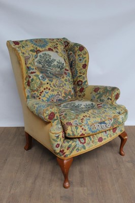 Lot 1359 - Georgian-style wing armchair, unusually upholstered in needlework depicting landscape panels and fruiting foliage within yellow ground, on cabriole front legs