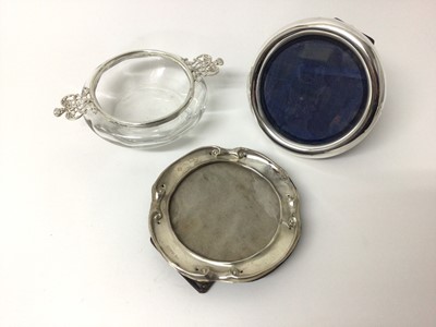Lot 196 - Circular silver photograph frame, Chester 1900, Art Nouveau silver photograph frame Chester 1906 and a William Comyns silver mounted glass two handled bon bon dish, London 1896