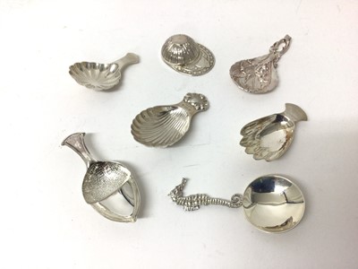 Lot 114 - Seven sterling silver caddy spoons, 1916 and later, including jockey cap, seahorse, hand, acorn, etc