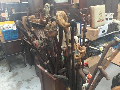 Lot 42 - Collection of novelty walking sticks and thumb sticks in two wooden stands - approx 40