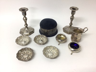 Lot 222 - Quantity of silver, including a pair of candlesticks, pin cushion, milk jug, a set of four embossed dishes, and a pair of George Unite tripod salts